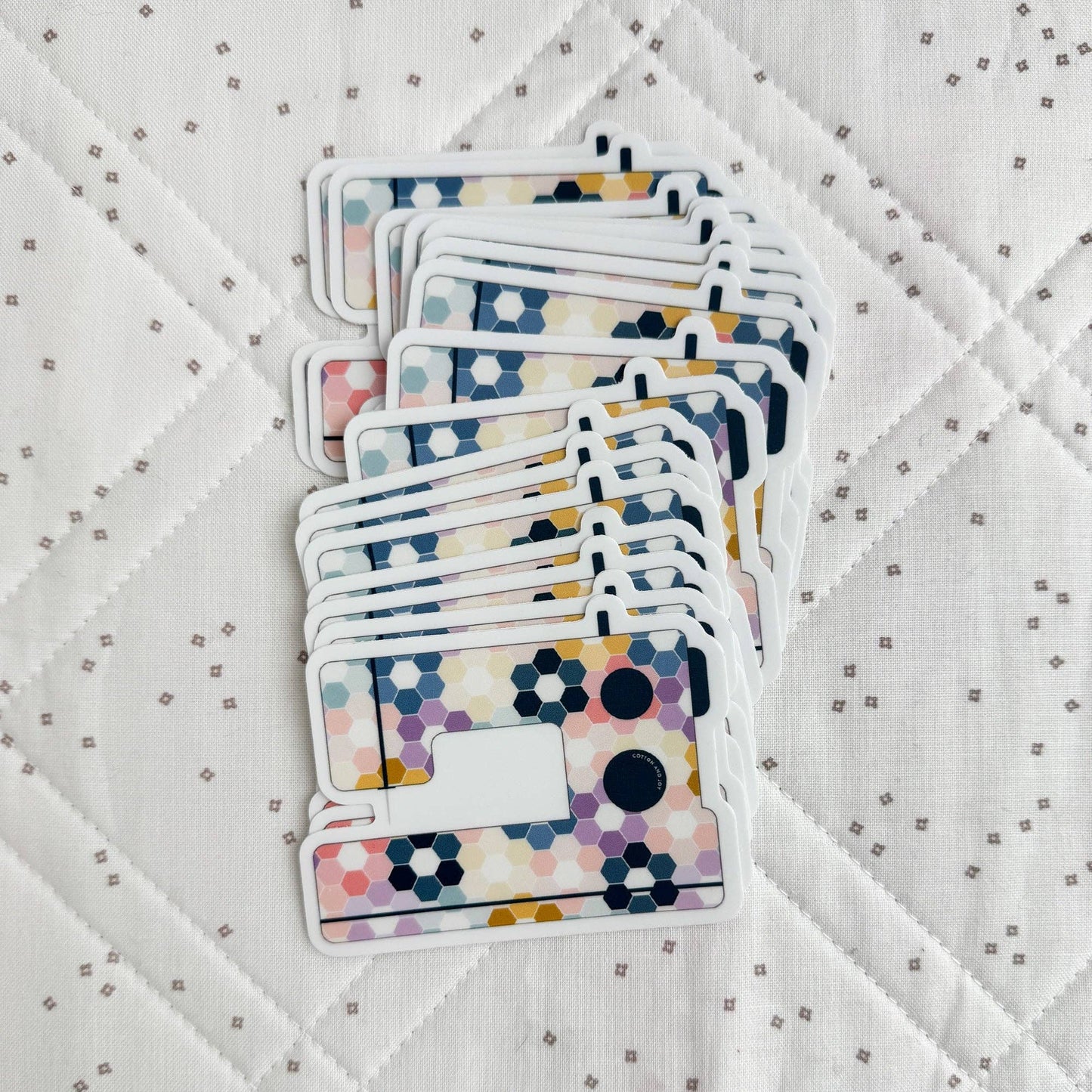 Stack of colorful playing cards on a textured white surface