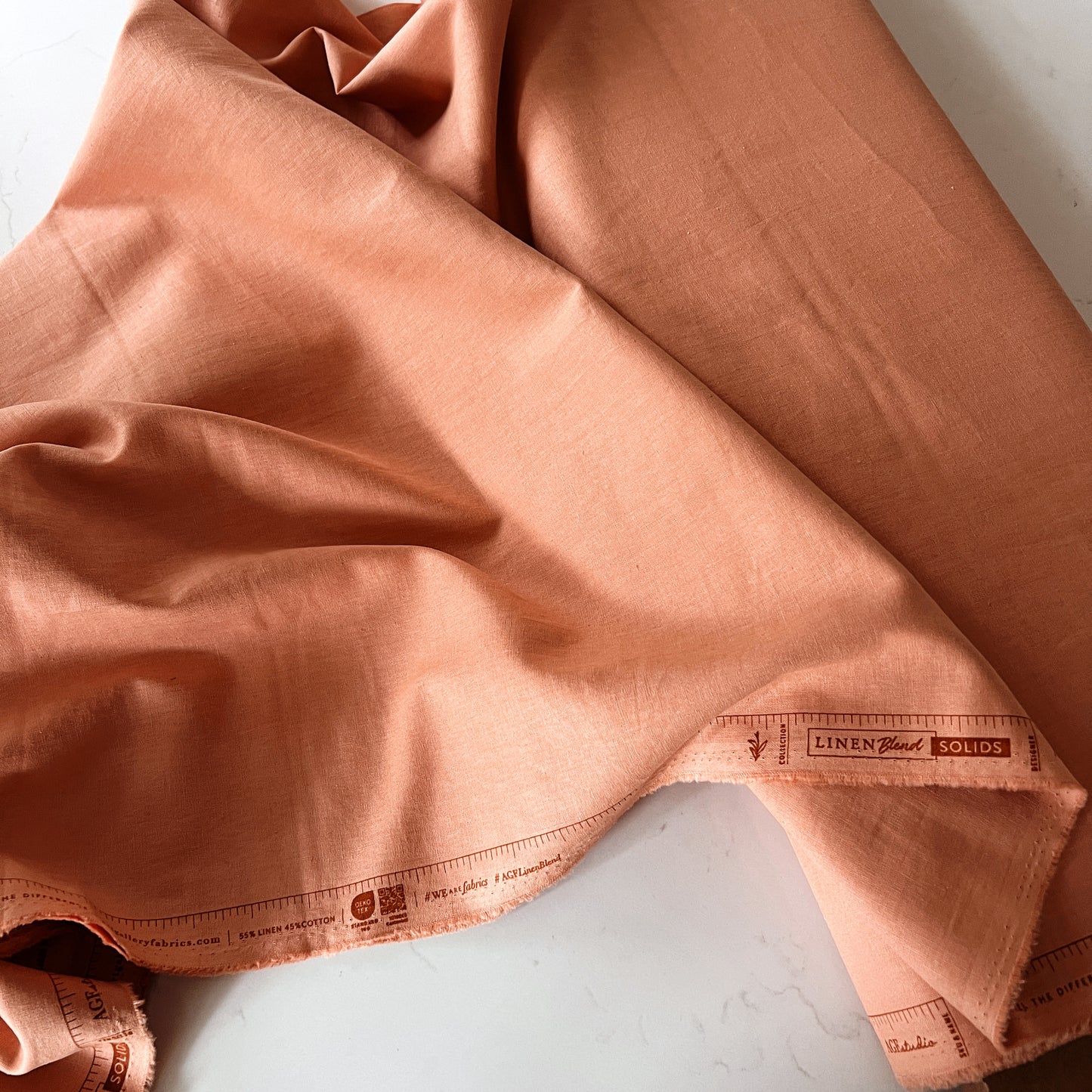 Warm sunkissed linen cotton blend fabric showing natural breathable fibers