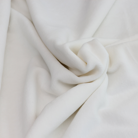 Close-up of organic cotton velour showing soft texture and natural off-white color