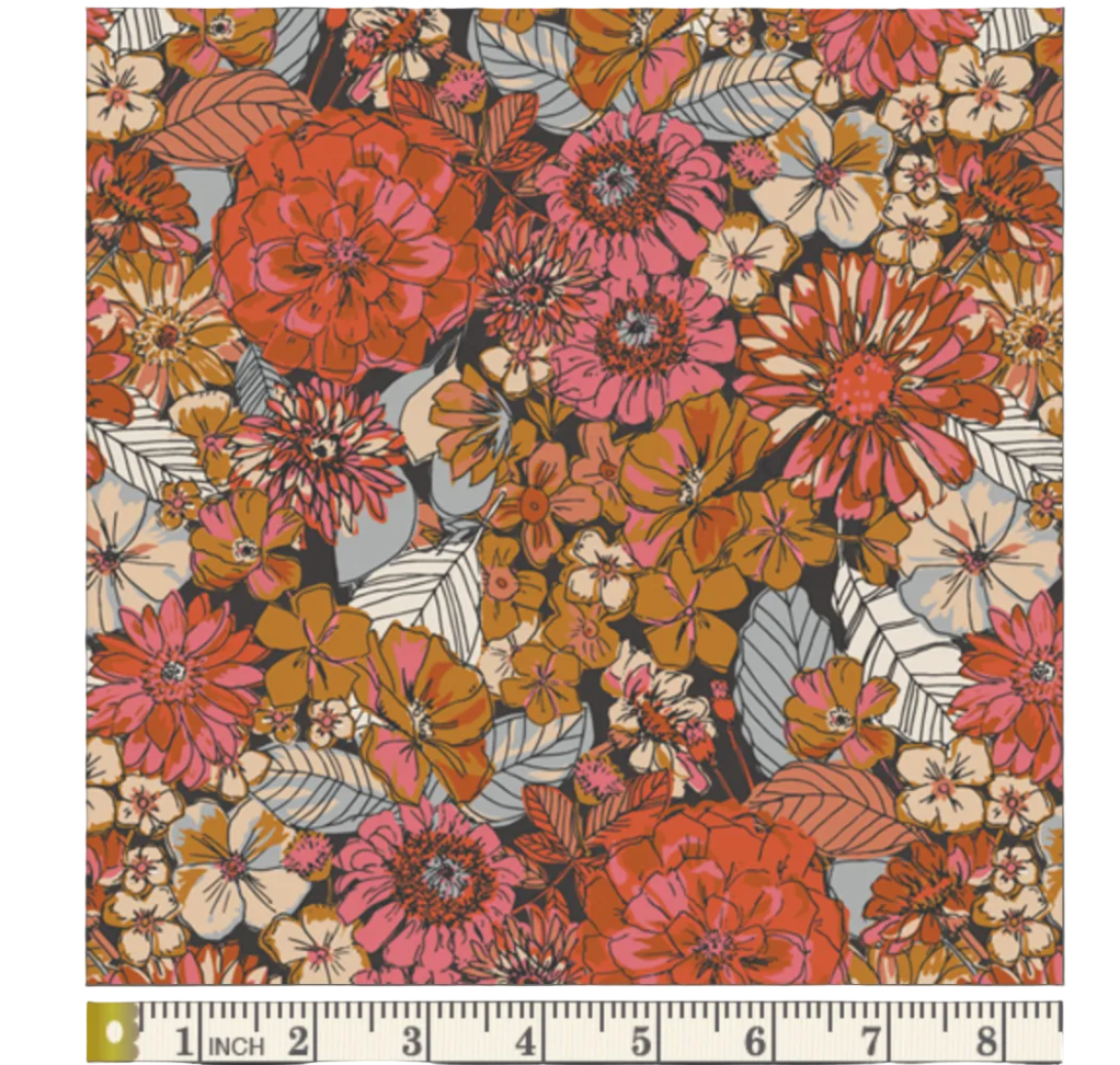 Floral pattern swatch with a ruler at the bottom for scale, on a dark background.