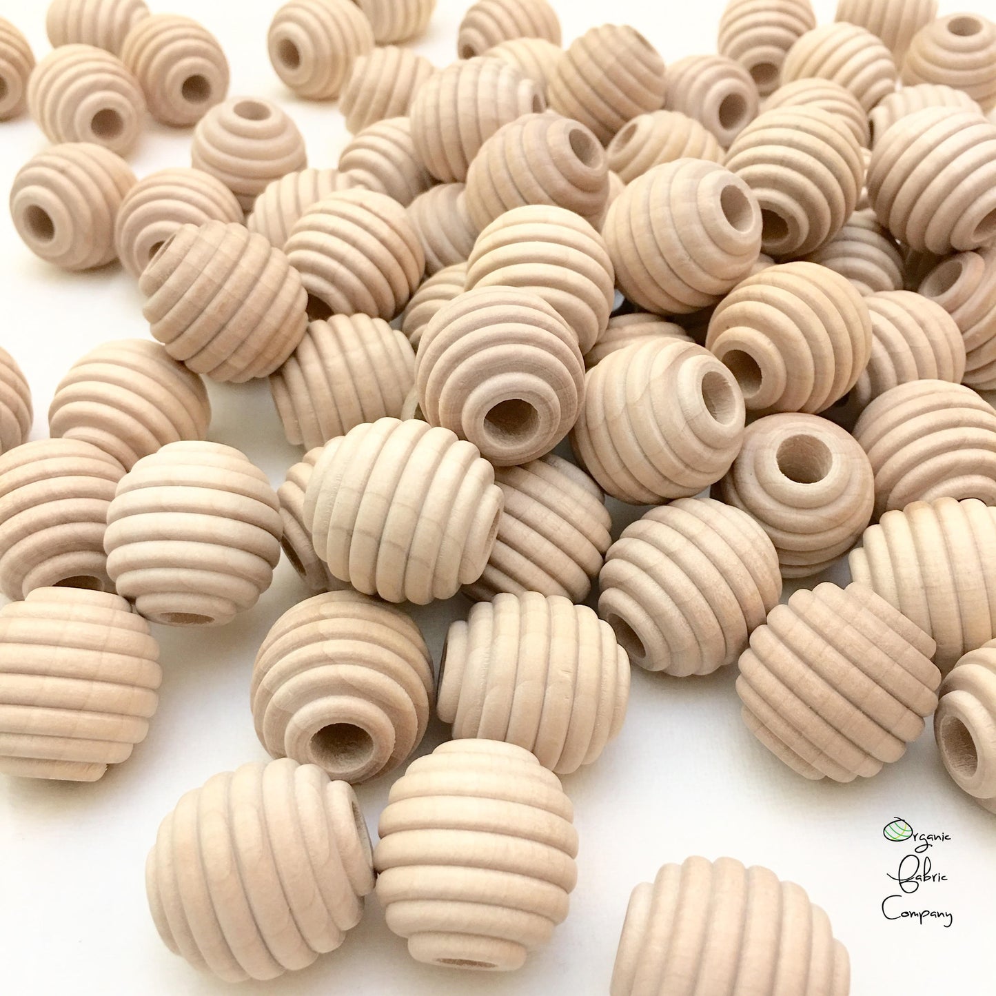 A collection of natural maple wood honeycomb textured beads with a 5/16 inch hole, displayed on a white background.