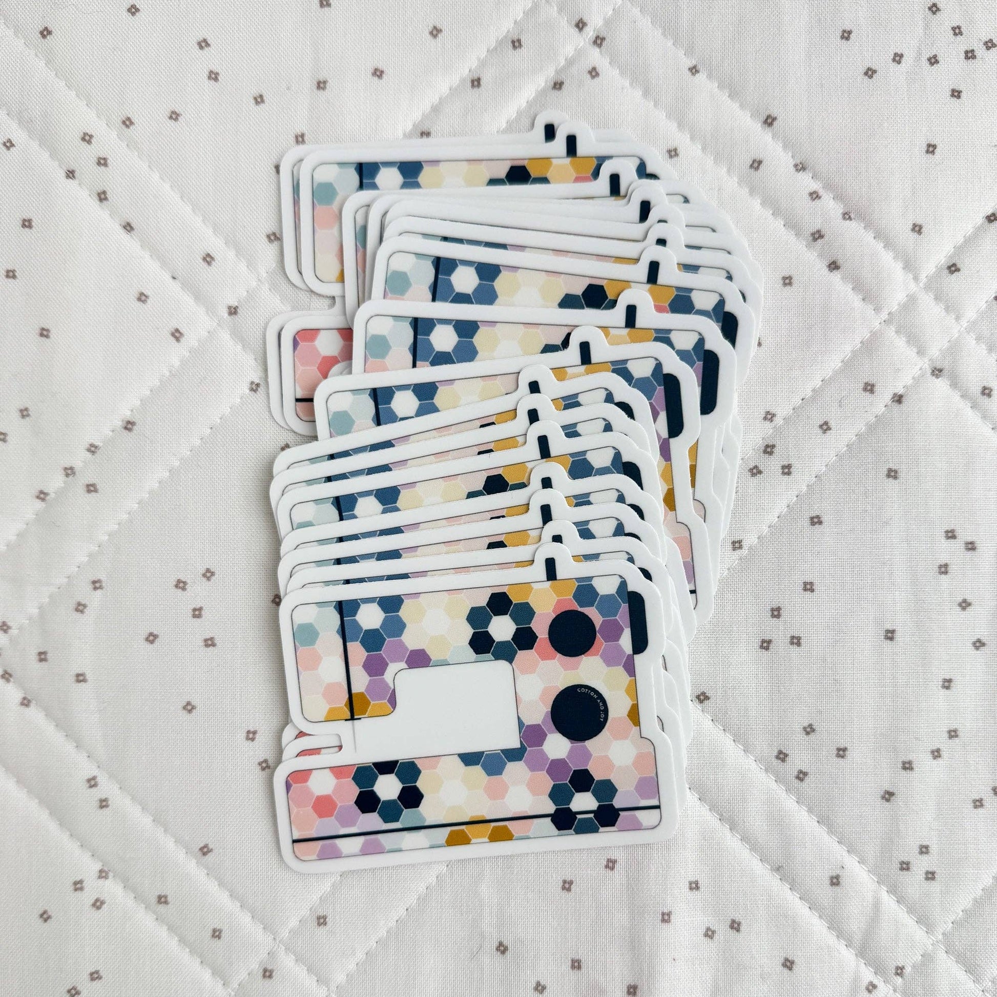 Stack of colorful playing cards on a textured white surface