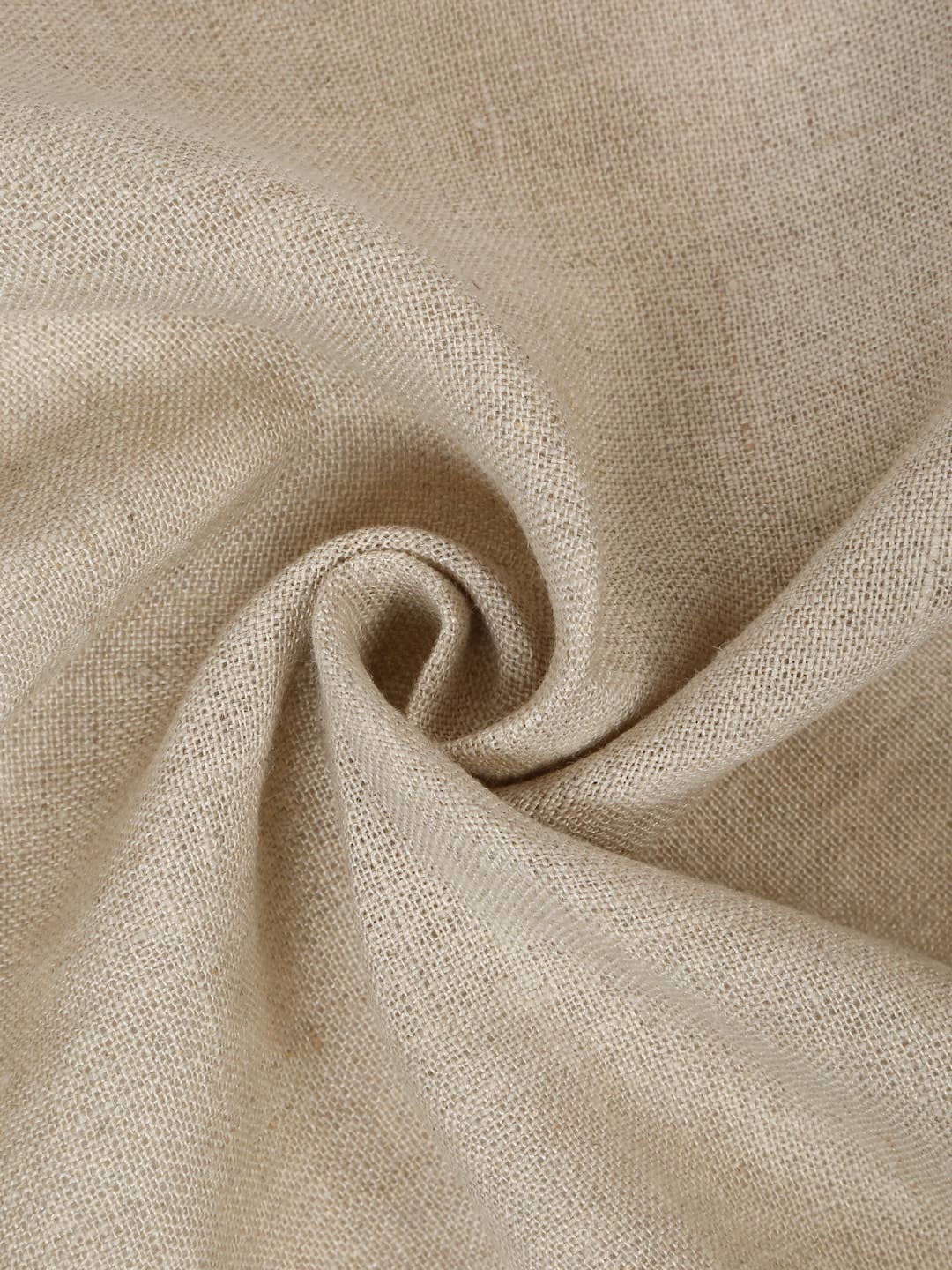 A close-up of a light beige linen fabric napkins with a soft, textured weave, artistically draped in a spiral pattern.
