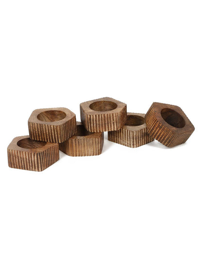 Wooden napkin rings with textured surface on a white background