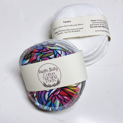 Cotton nursing pads with colorful design in packaging on a white background
