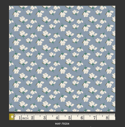 Pattern of white flowers on a blue background with a ruler at the bottom.