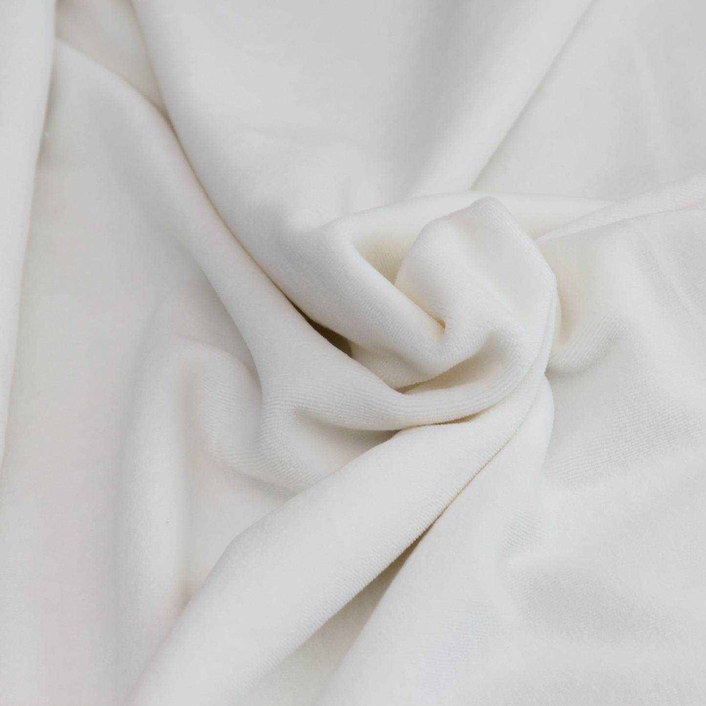 Close-up of organic cotton velour showing soft texture and natural off-white color