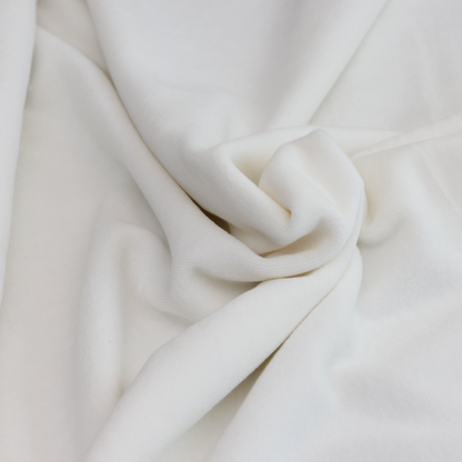 Close-up of organic cotton velour showing soft texture and natural off-white color
