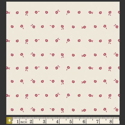 White fabric with red floral pattern and ruler at the bottom for scale.