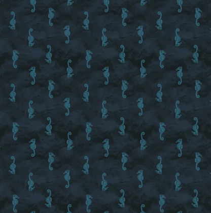 Dark navy blue fabric with a repeating pattern of small teal seahorses, shown flat with a white ruler along the bottom edge for scale.