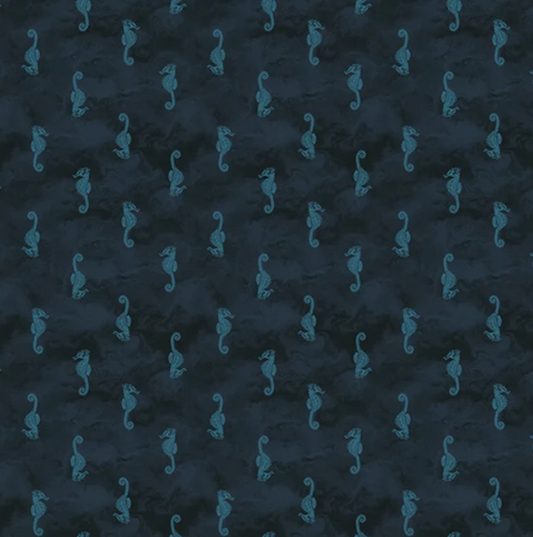 Dark navy blue fabric with a repeating pattern of small teal seahorses, shown flat with a white ruler along the bottom edge for scale.